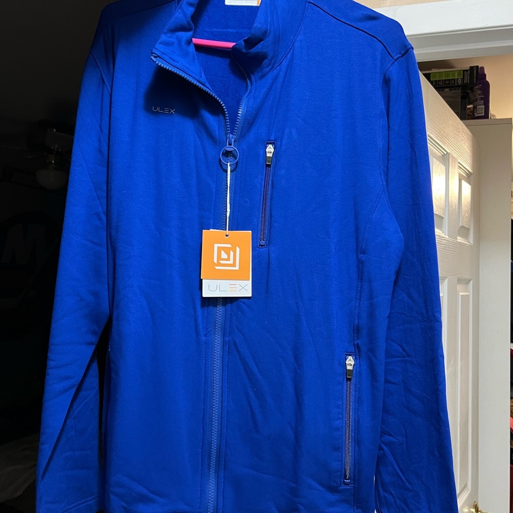 3 men’s dry fit long sleeve tops with tags.